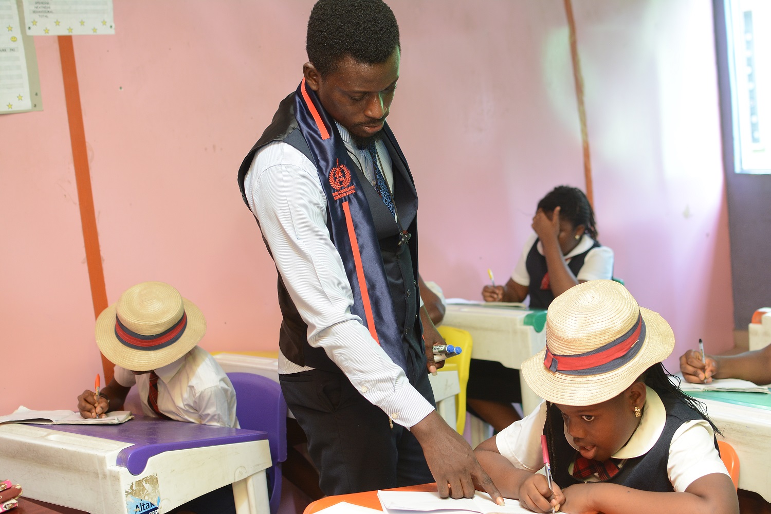 Teacher guiding students at Bwills Online Academy